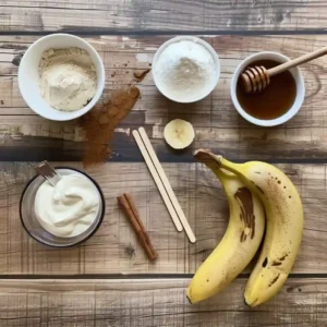Ingredients for banana vanilla protein ice pops laid out on a wooden surface