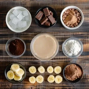 Protein Fluff That Actually Fills You Up (Without the Powdery Taste) 7 Ingredients for chocolate banana protein fluff laid out on a wooden surface
